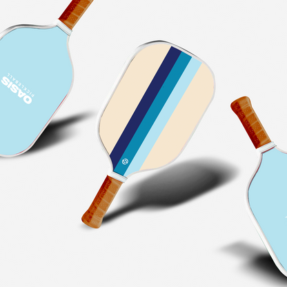 A set of three pickleball paddles with blue and white striped designs, lying flat with the 'Anchor Bay' brand visible.
