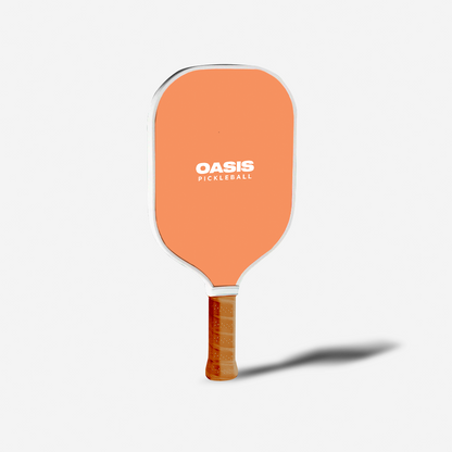 Orange pickleball paddle with 'Oasis Pickleball' branding on a white background